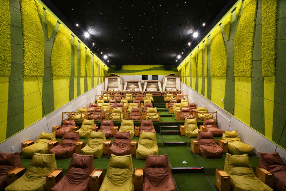 Movie theater interior decorated with green terrier Scandiamoss-CGV Cheonan Cine & Foret theater